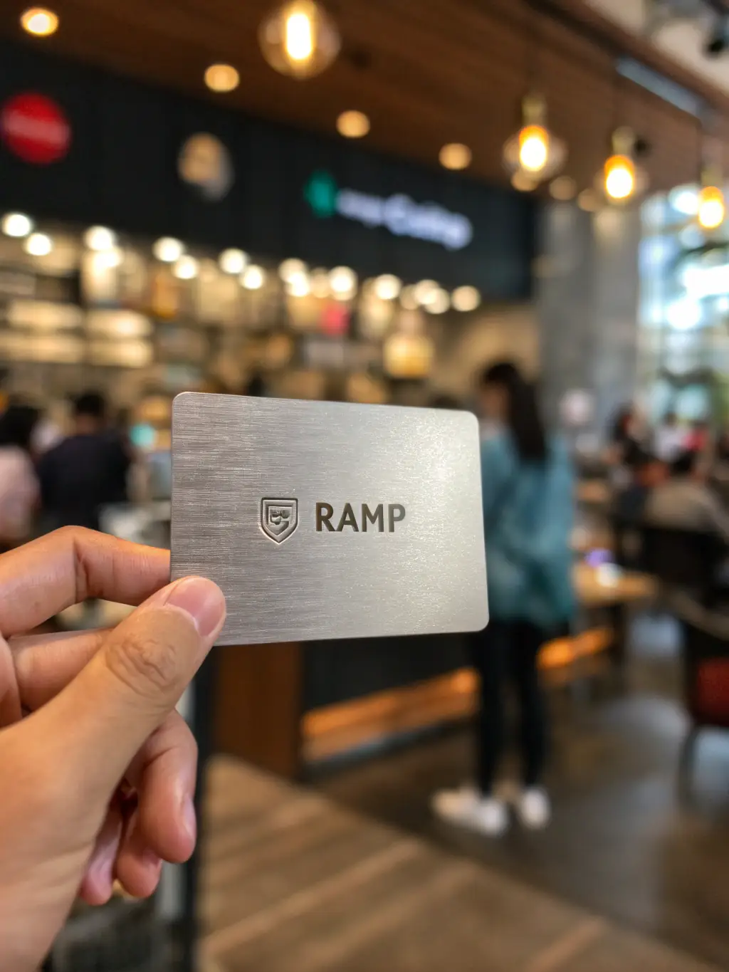 A professional, close-up shot of a Ramp corporate credit card, emphasizing its sleek design and security features. The card is resting on a modern desk with a blurred office background.